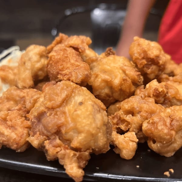 Close-up of a plate piled high with golden-brown, crispy Japanese fried chicken karaage.